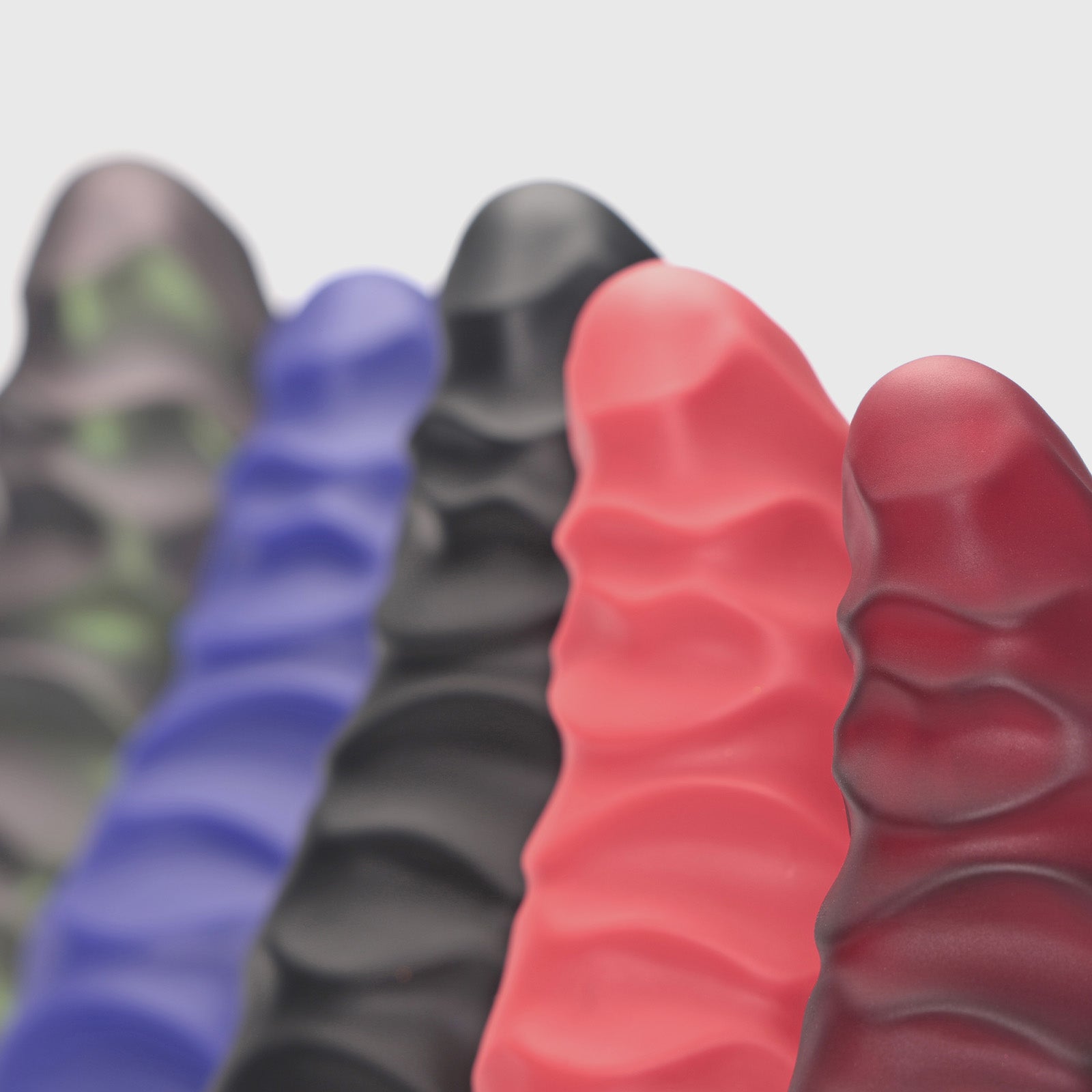 GreedyCluster ABADDON textured silicone dildo color lineup with layered armored ridges